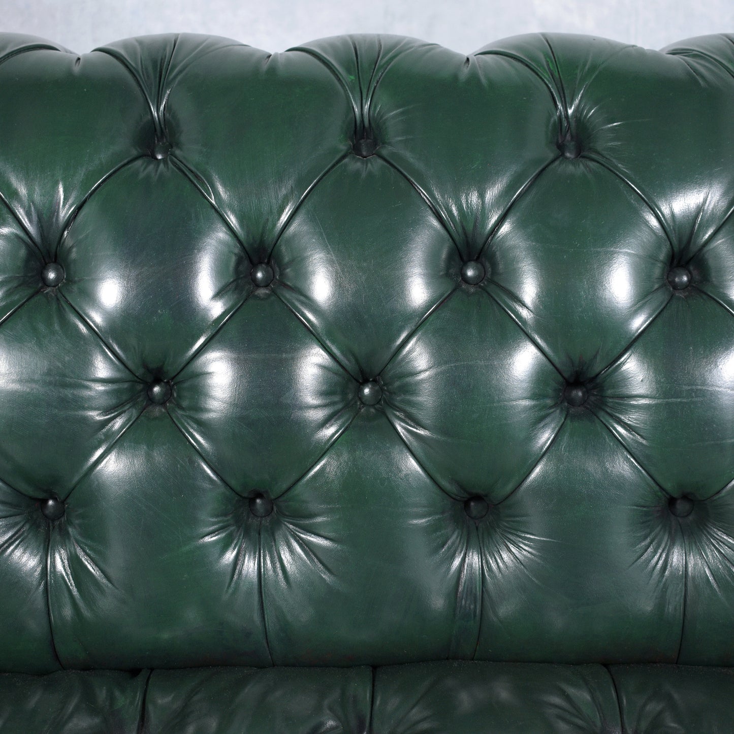 1970s Vintage Chesterfield Sofa: Emerald Green Leather with Elegant Carved Legs