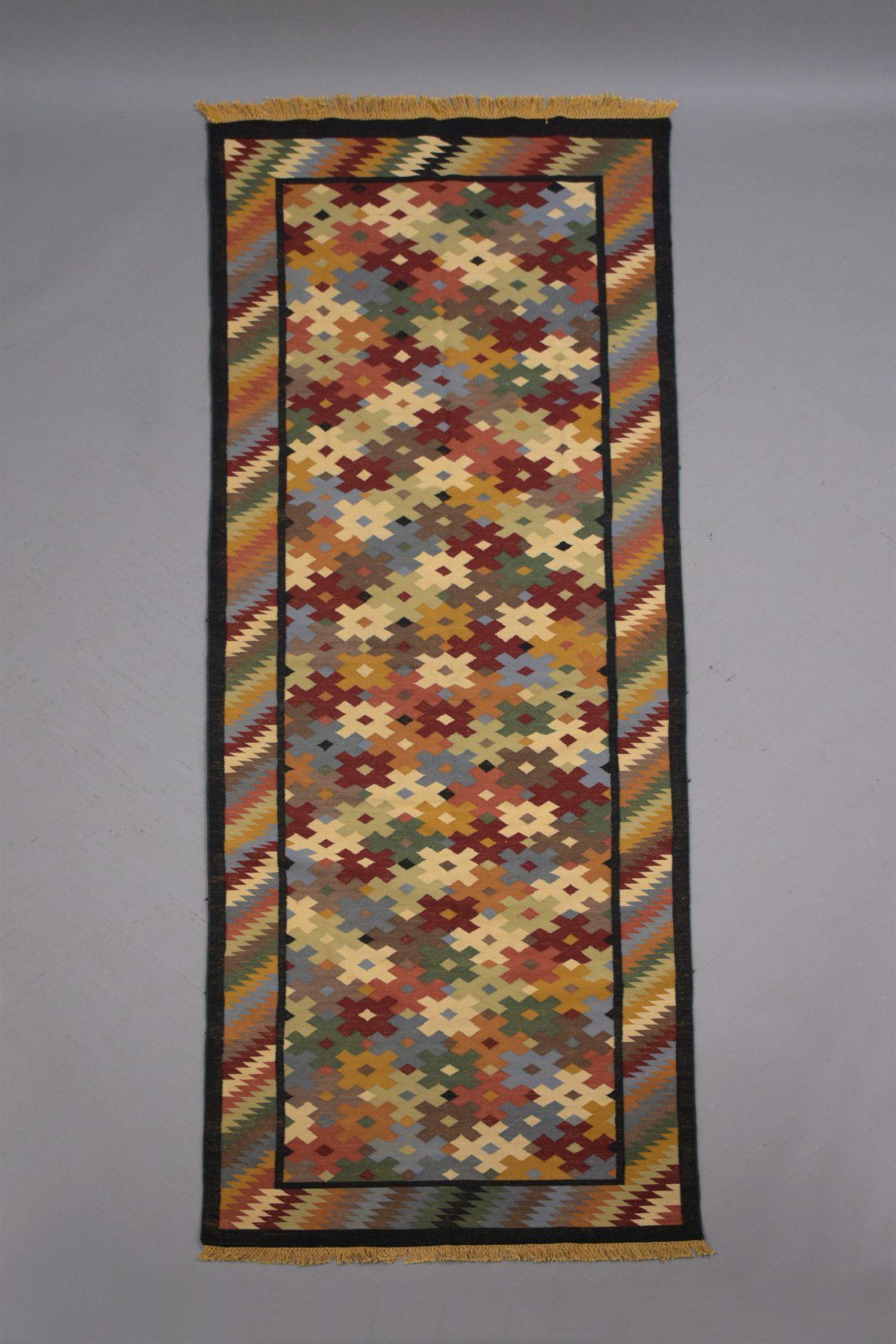 Early 1900s Multicolor Symmetrical Pattern Textile Rug: Perfect for Sophisticated Spaces